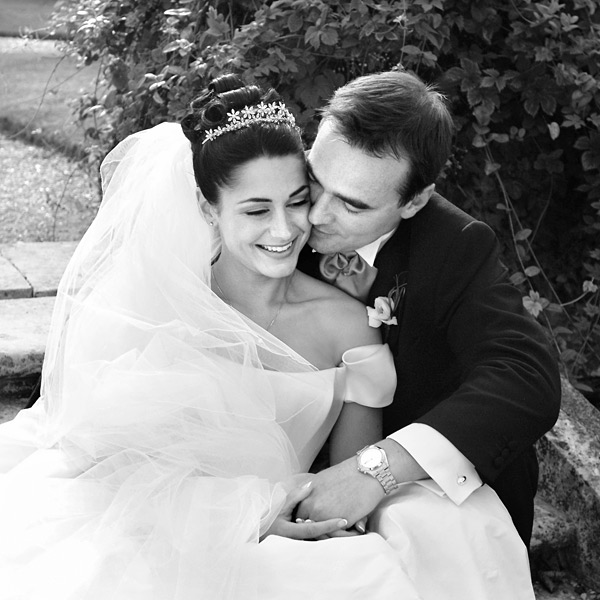 I used a flight of stone steps to form the base of this shot. The groom was sat on the step above the bride and she is sat within his legs leaning back into him. I like to ensure the cuff links and watch are visible on the groom when I’m shooting wedding couples. They are blissfully delighted and intimately unaware of those around them. ISO 400, 1/1500th second at f/4