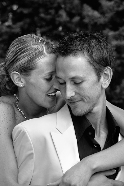 couples_04 This uber stylish bride and groom were shot in much the same way. I asked the bride to snuggle in from the rear this time. Dipped heads, closed eyes and a passionate warm expression that comes from the heart was all we needed. The smiles of contentment are perfect for a wedding day. Anything more lustful or implying is best left for pre and post wedding shoots. I love attention to styling details like the brides neckless matching the wave in her hair parting line and the grooms open necked black shirt contrasting with his white suit.