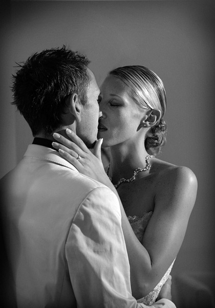 couples_12 Here is the same moment but on a wedding day from 2003. I lit the bride and groom with my Arri 300 Fresnel spotlight to give a classic movie feel to the shot. It is nothing new to say the moment just before the kiss is the one to shoot, not the kiss itself but it needs saying none the less. Eyes closed is another golden rule for the ‘just about to kiss’ shot. Fujifilm S2 with a 70-200mm lens at f/4. I used ISO 800 and 1/125th second exposure.
