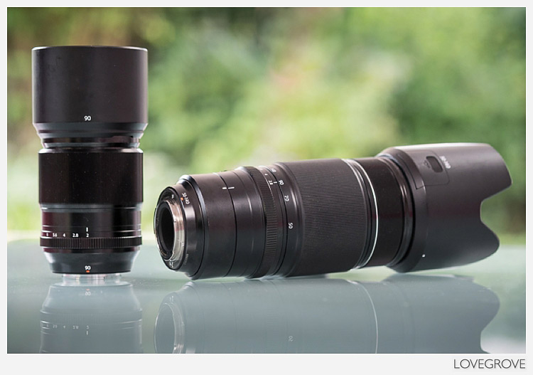 The Fuji XF 90mm f/2 lens on the left is significantly smaller and lighter than the XF 50-140mm lens on the right.