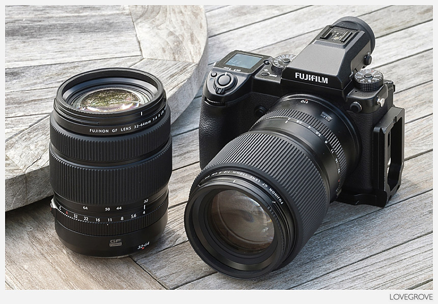A comparison shot showing the Fujifilm GF 32-64mm lens alongside the Fujifilm GF 110mm f/2