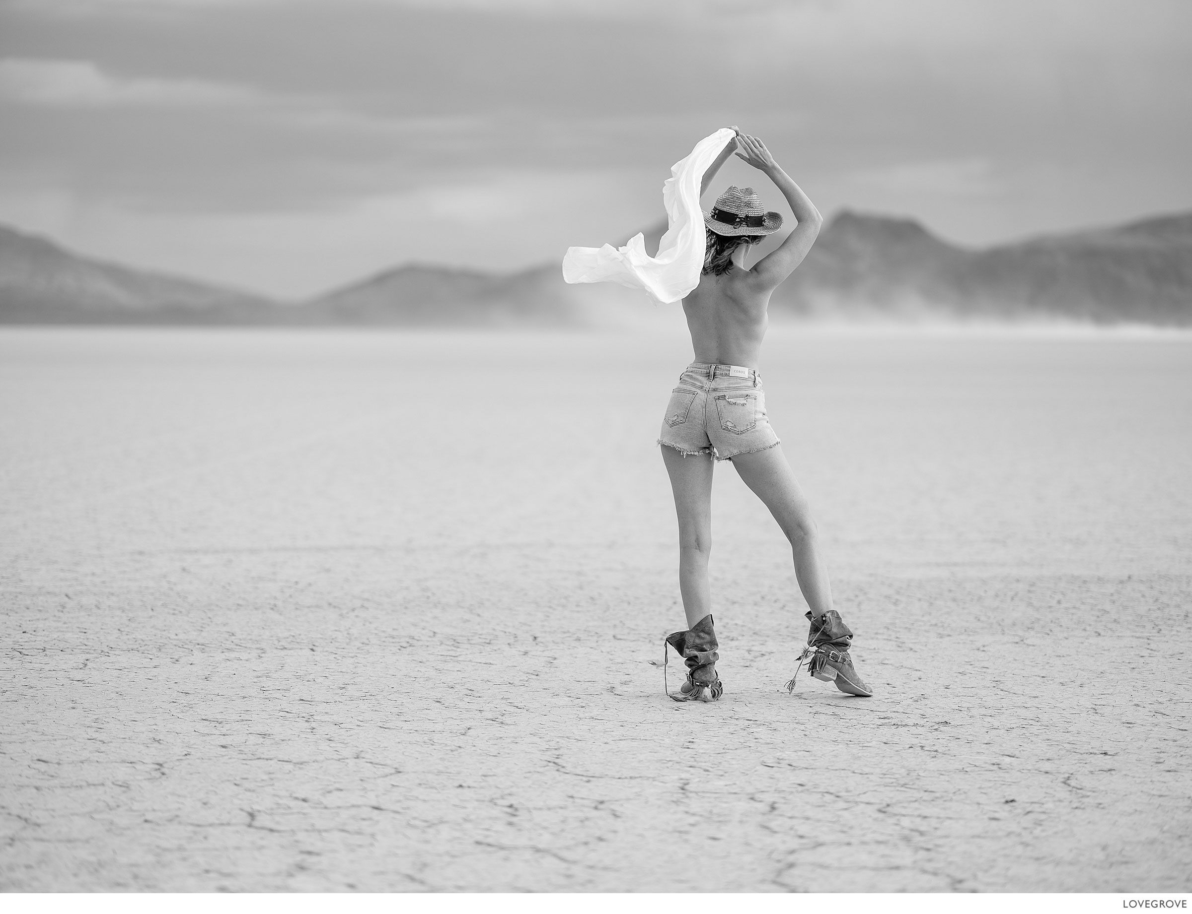 A girl turned away from camera on a dried up lake bed